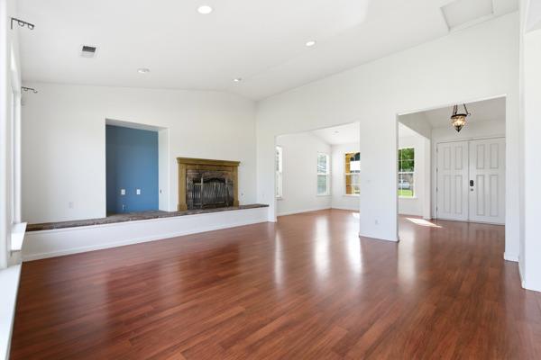 384 Millbrook Street Hanford, CA 93230 - Photo 10 of 59 a view of an empty room with wooden floor and a cabinet