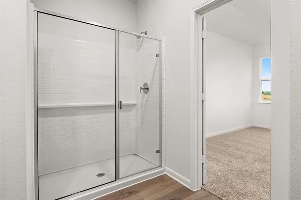 a bathroom with a glass shower door