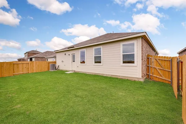 a view of a backyard with plants and a backyard