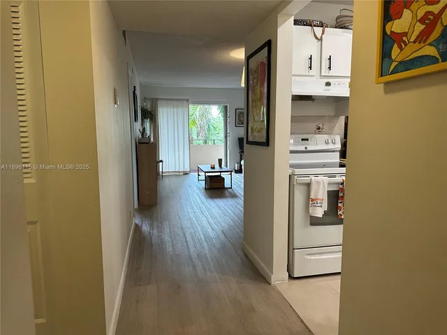 a view of hallway with wooden floor