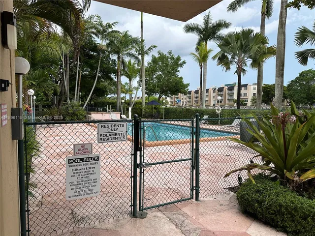 a view of a backyard with furniture and a fire pit