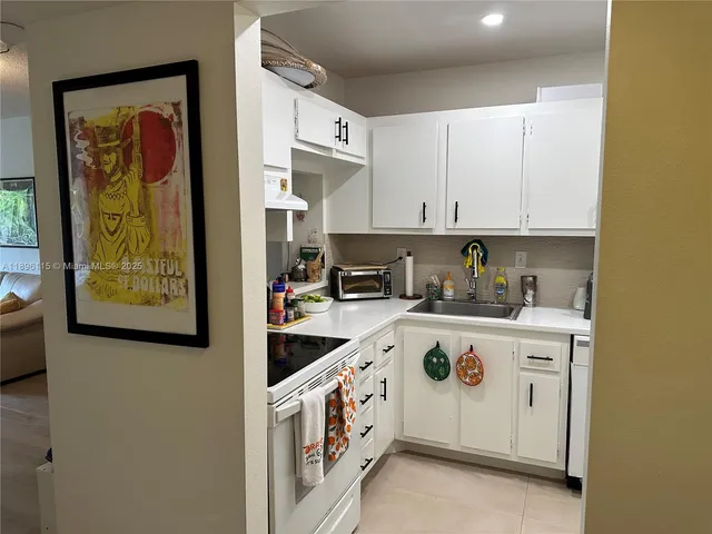 a kitchen with cabinets and white appliances