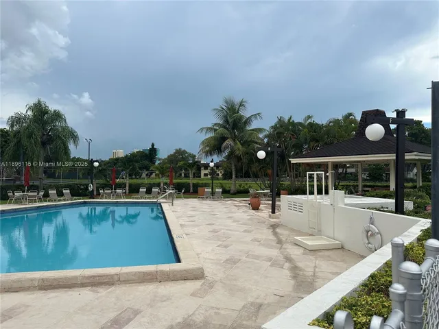 a view of a patio with table and chairs potted plants and a fountain