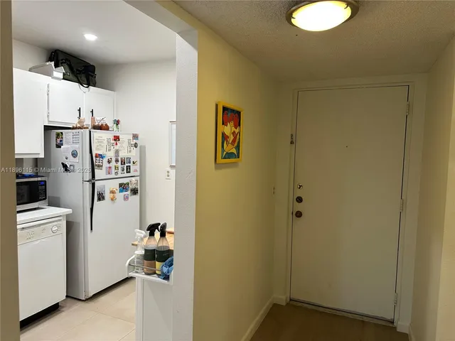 a white refrigerator freezer sitting in a kitchen