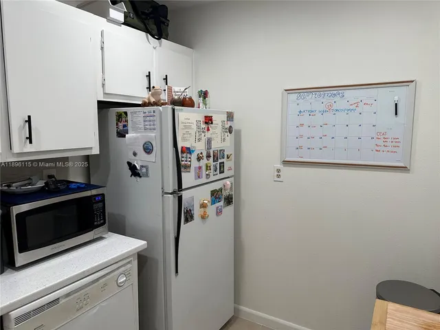 a kitchen with kitchen island a sink a stove and cabinets