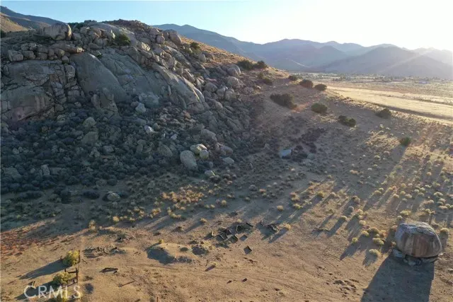 a view of a dry yard with mountain