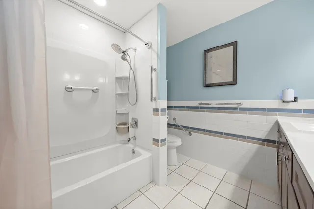 a bathroom with a bathtub a toilet and a shower