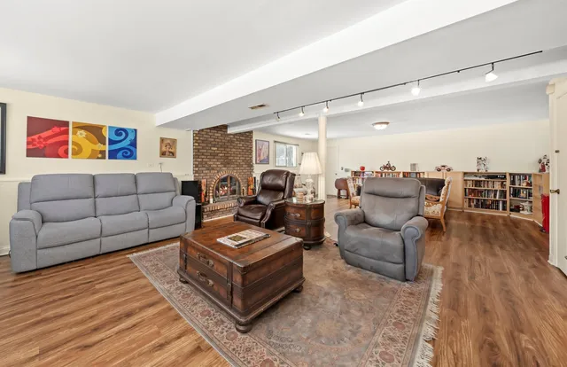 a living room with furniture and a wooden floor