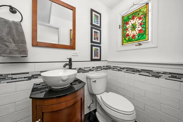 a bathroom with a toilet a sink and a mirror