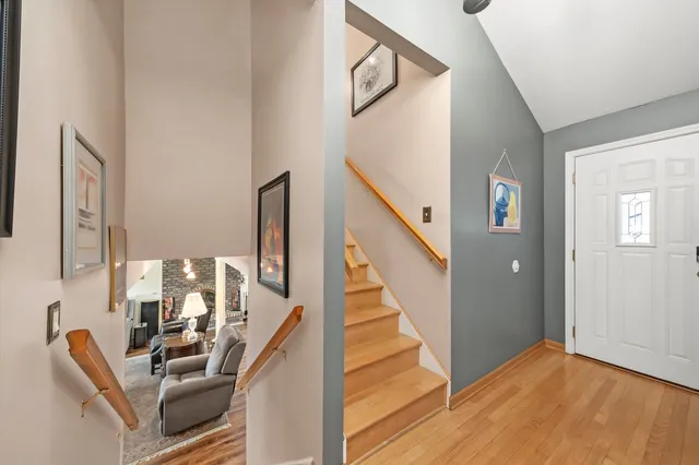 a view of an entryway with wooden floor and stair