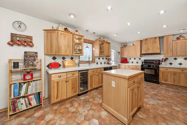 a kitchen that has a lot of cabinets in it and appliances