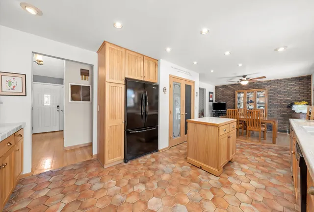 a kitchen with stainless steel appliances a refrigerator and a stove top oven