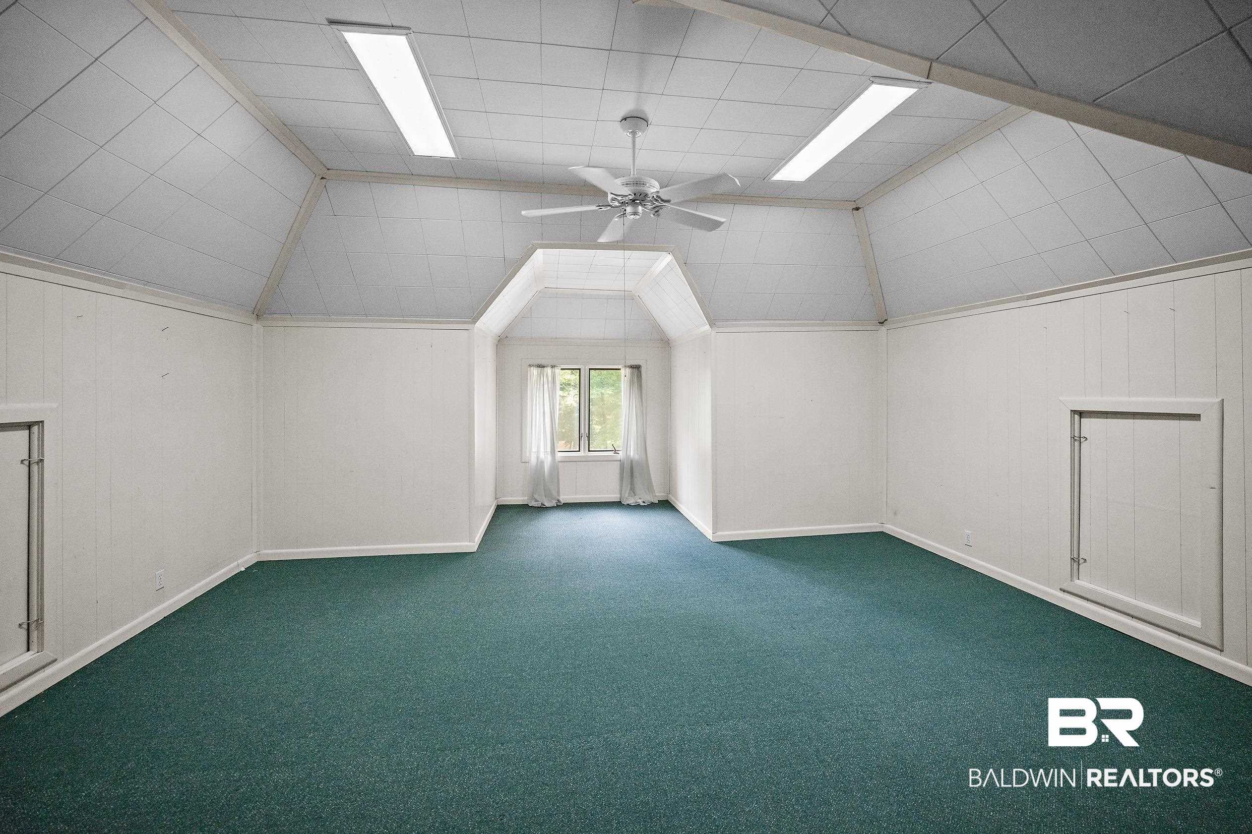 329 Norwood Road Monroeville, AL 36460 - Photo 34 of 49 Vaulted ceiling room featuring paneling walls and green carpet flooring