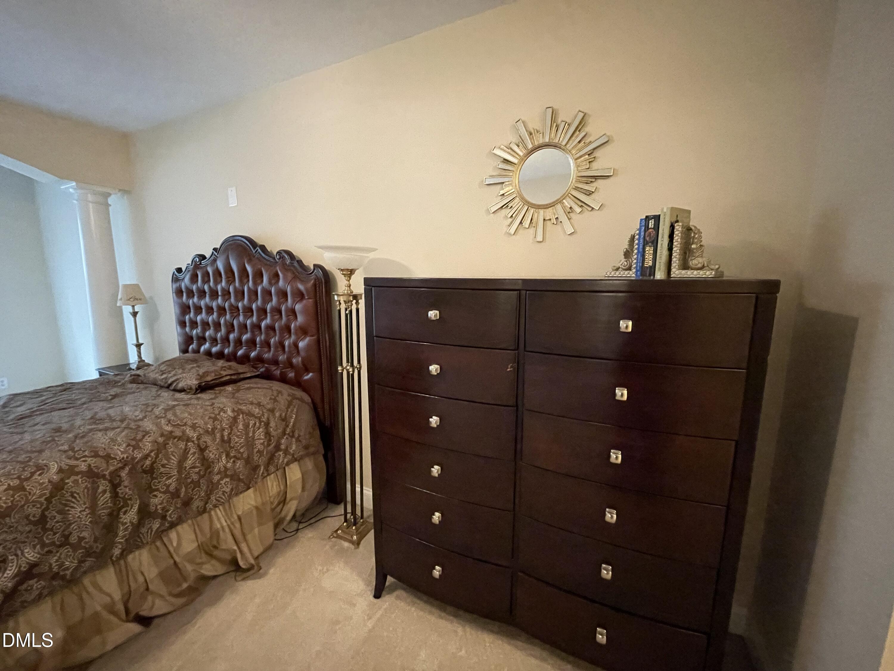 10411 Rosegate Court, Unit 3 Raleigh, NC 27617 - Photo 33 of 62 a bedroom with a bed and a chandelier