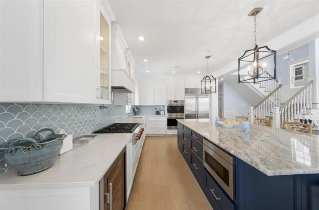 174 23rd Street Avalon, NJ 08202 - Photo 11 of 23 a kitchen with stainless steel appliances granite countertop a sink a stove and a wooden floors