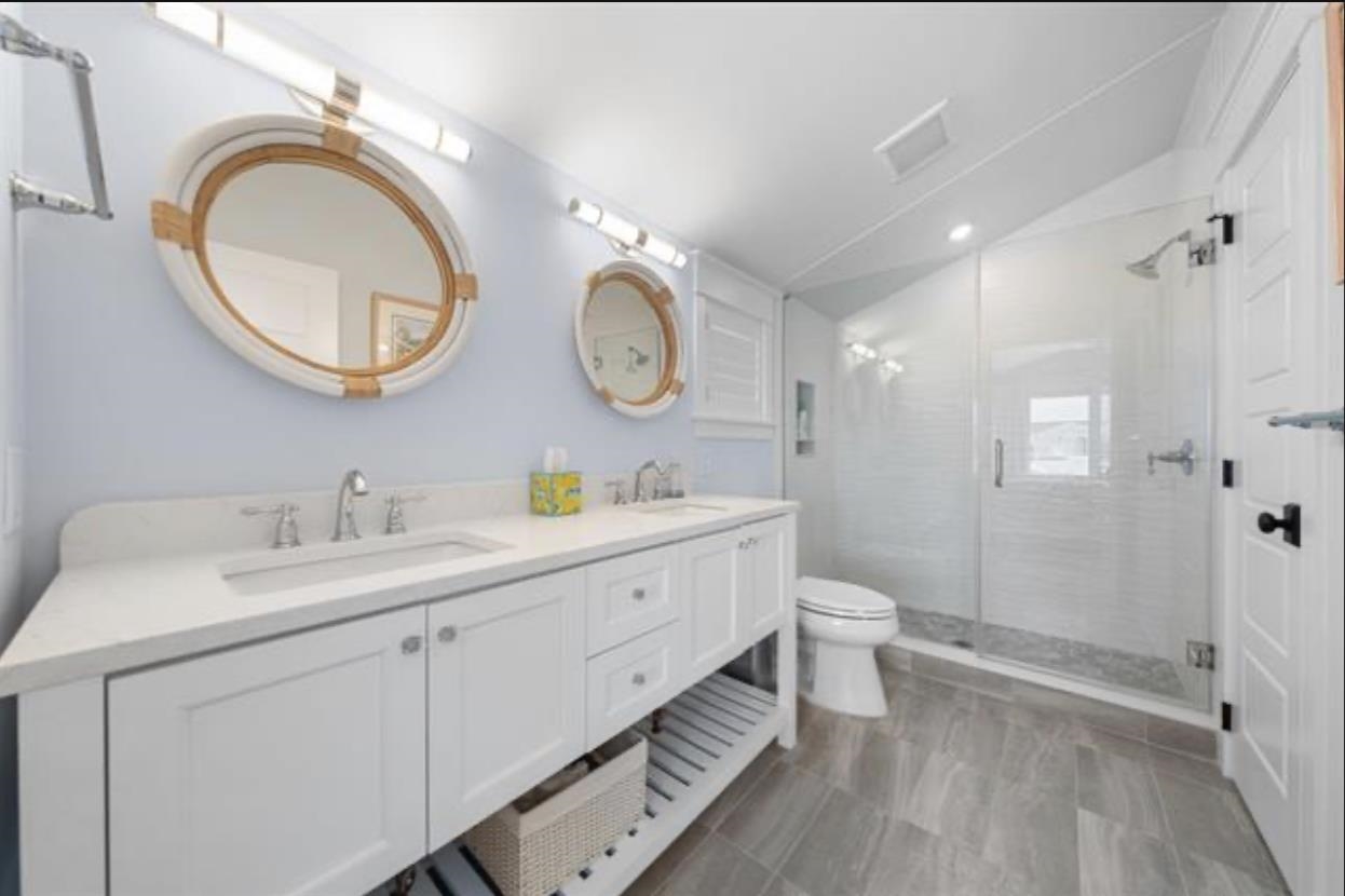 174 23rd Street Avalon, NJ 08202 - Photo 15 of 23 a spacious bathroom with a double vanity sink a mirror and a toilet