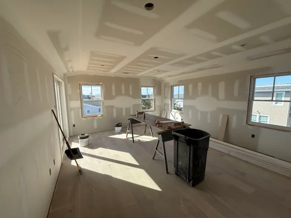 a view of a dining room with furniture a livingroom and chandelier