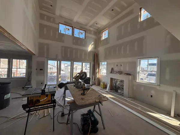 a living room with furniture a fireplace and a large window