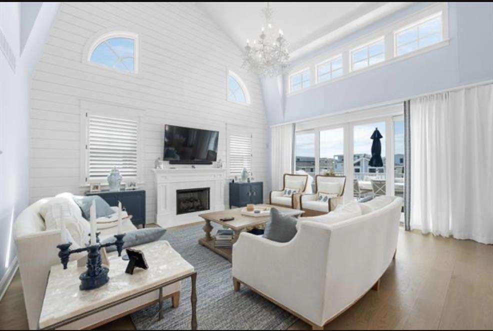 174 23rd Street Avalon, NJ 08202 - Photo 8 of 23 a living room with furniture a fireplace and a flat screen tv