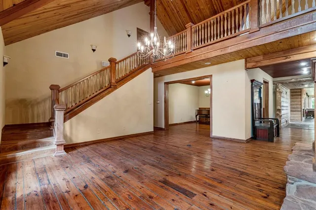 a view of a room with wooden floor and staircase