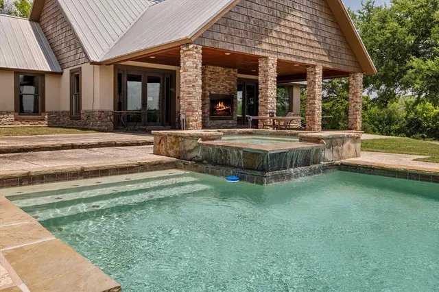 a view of a house with sitting area and swimming pool