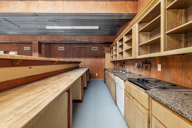 a kitchen with stainless steel appliances granite countertop a stove and a sink