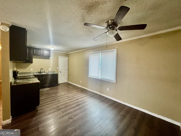 a view of a kitchen with a sink wooden floor and a window