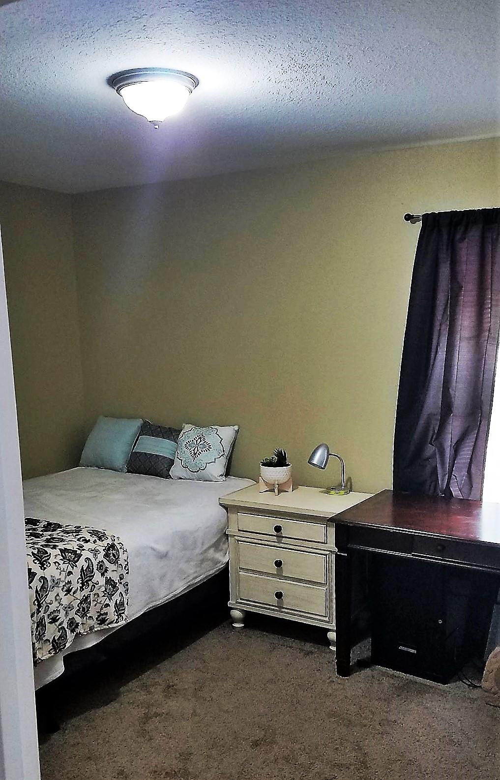 3111 Auburn Road Crestview, FL 32539 - Photo 11 of 16 a bedroom with a bed and a night stand