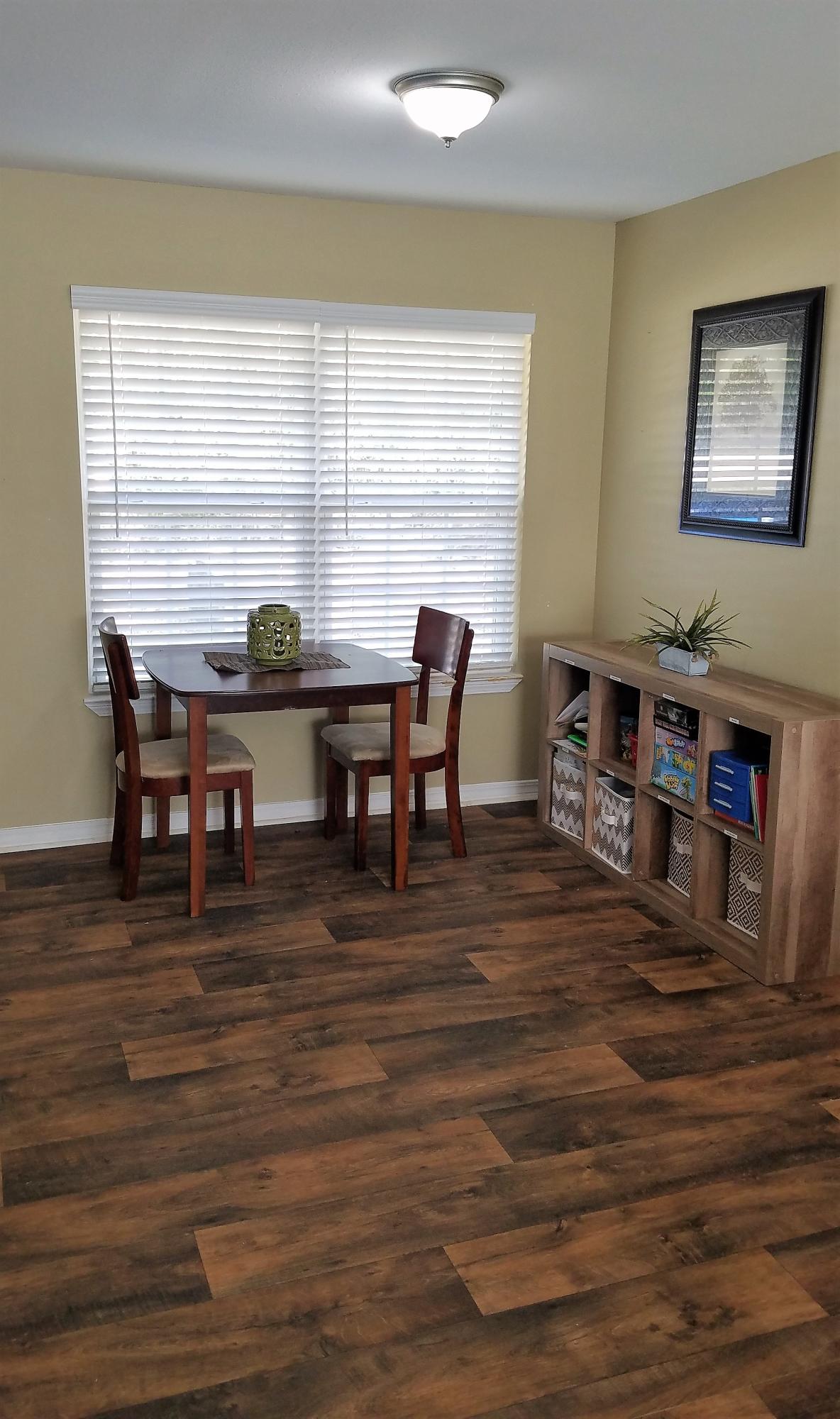 3111 Auburn Road Crestview, FL 32539 - Photo 5 of 16 a view of a dining room with furniture window and wooden floor