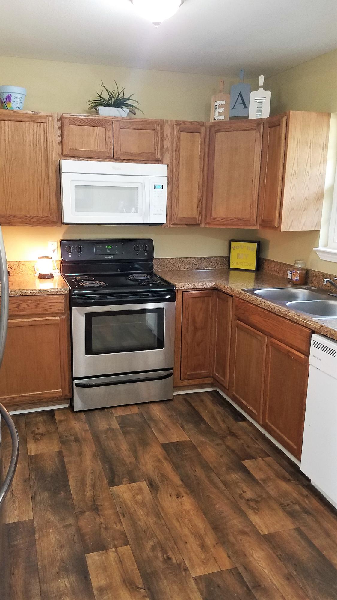3111 Auburn Road Crestview, FL 32539 - Photo 7 of 16 a kitchen with stainless steel appliances granite countertop a stove a sink and a microwave