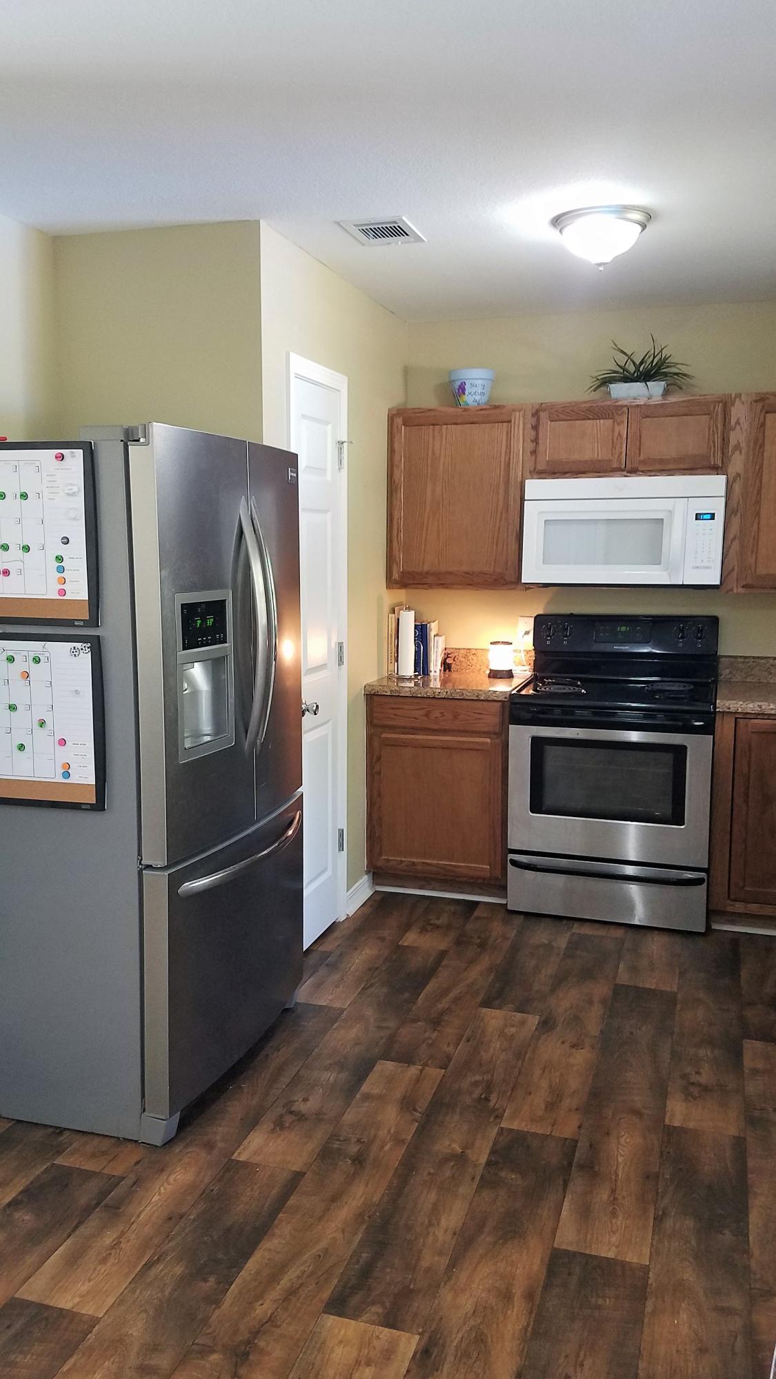 3111 Auburn Road Crestview, FL 32539 - Photo 8 of 16 a kitchen with a refrigerator and a stove