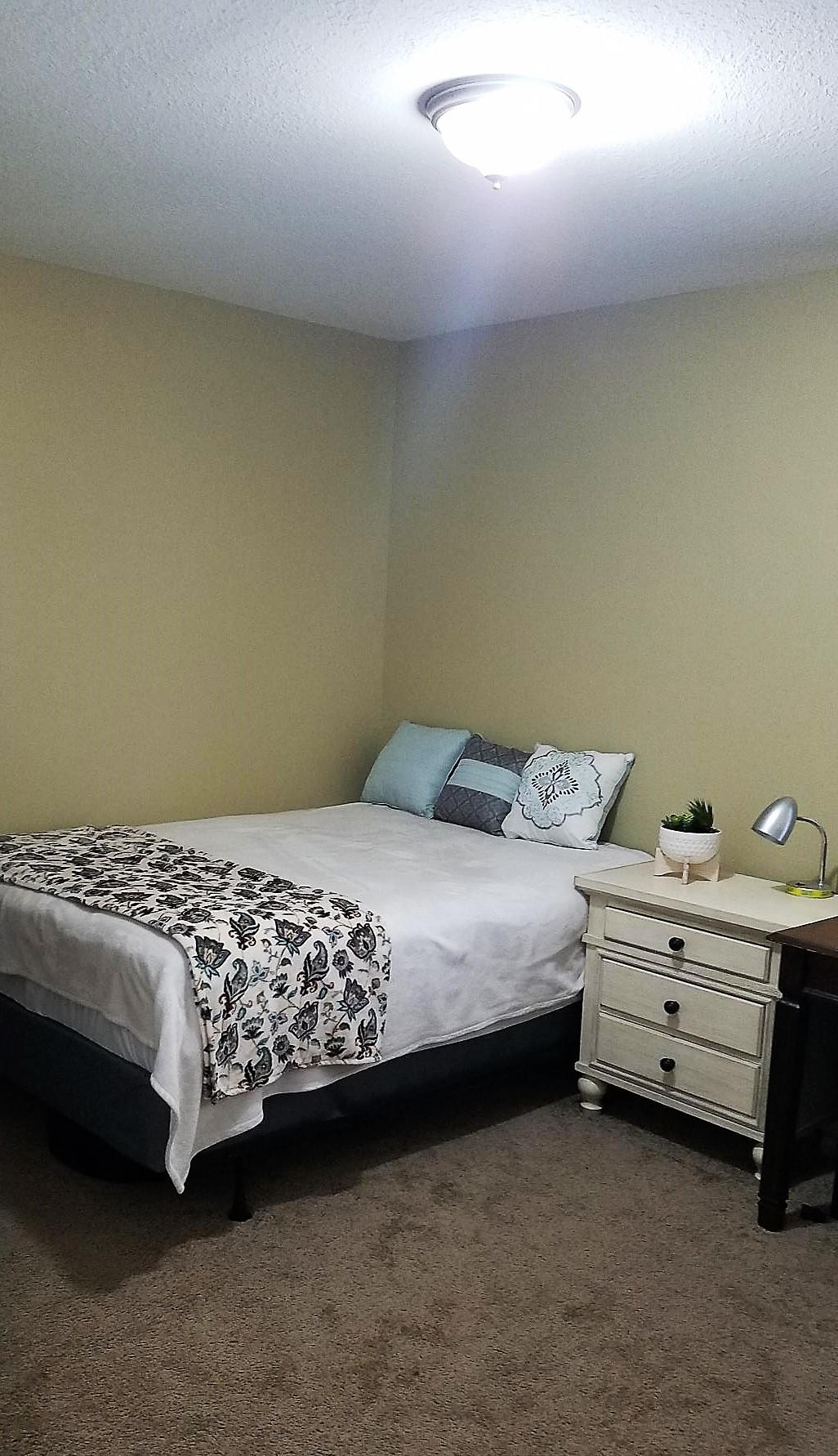 3111 Auburn Road Crestview, FL 32539 - Photo 10 of 16 a bedroom with a bed dresser and a window