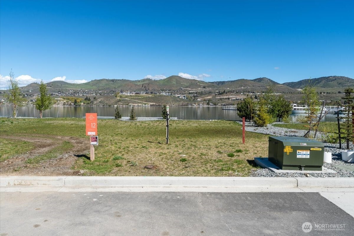 105 Bass Lane Chelan, WA 98816 - Photo 15 of 29 a view of a lake with a houses in the background