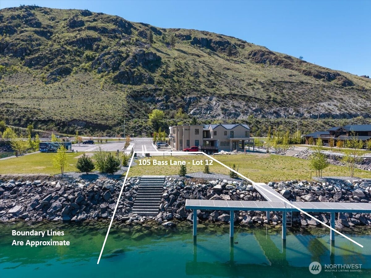 105 Bass Lane Chelan, WA 98816 - Photo 5 of 29 a view of a swimming pool with a garden and wooden fence