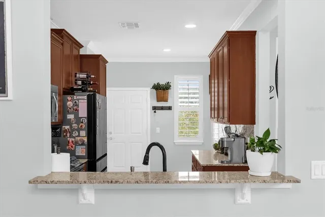 a kitchen with a refrigerator and a sink