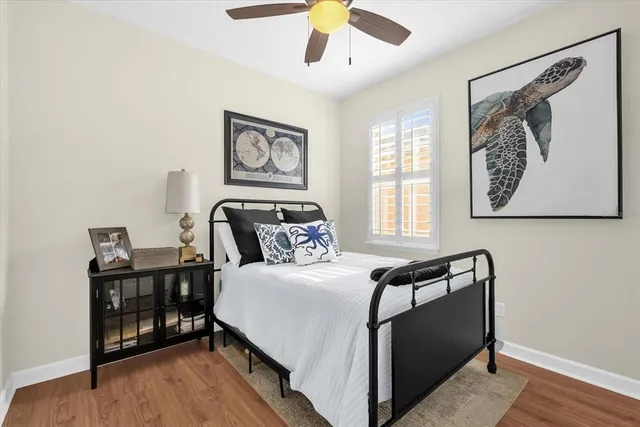 a bedroom with bed and wooden floor