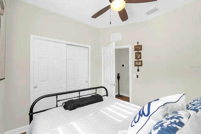 a bedroom with a bed and ceiling fan