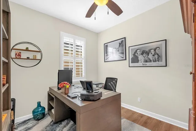 a view of a workspace with furniture and a window