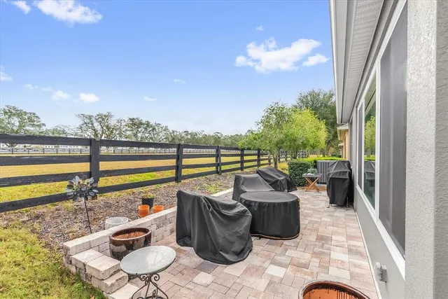 a view of a chairs and table in patio