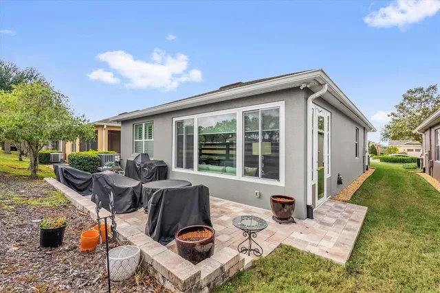 a view of backyard of house with seating space