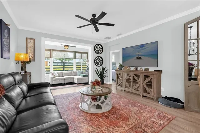 a living room with furniture a rug and a window