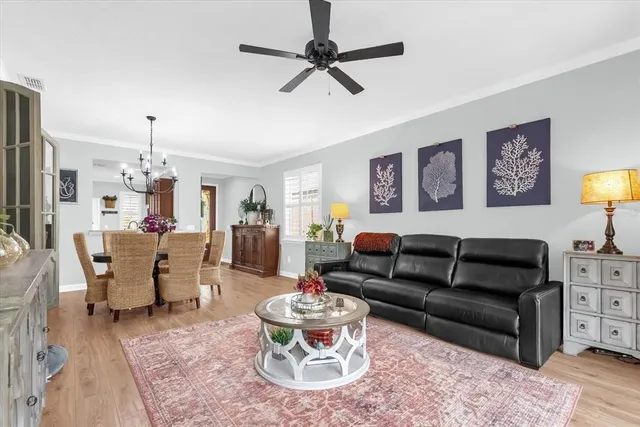 a living room with furniture and a chandelier