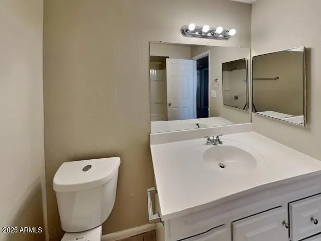 a bathroom with a sink a toilet and mirror