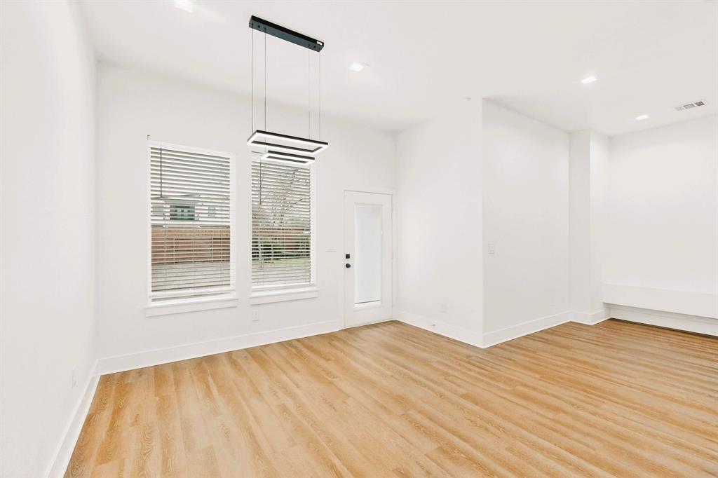 1218 Grant Street Dallas, TX 75203 - Photo 6 of 40 a view of empty room with wooden floor and fan