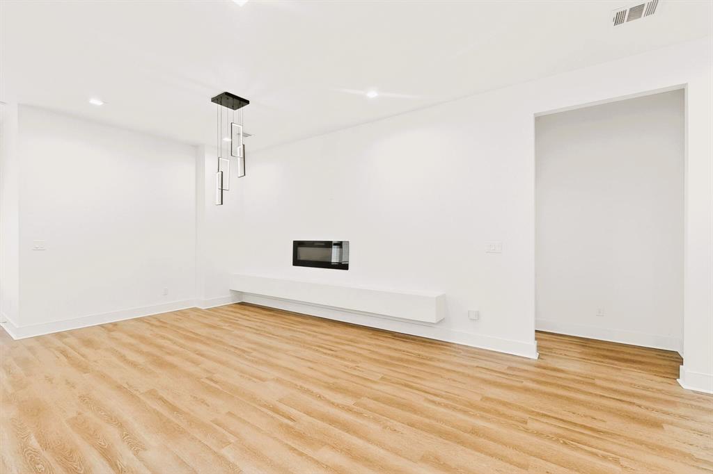 1218 Grant Street Dallas, TX 75203 - Photo 9 of 40 a view of empty room with wooden floor