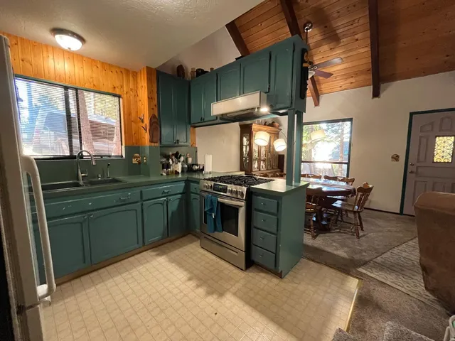 a kitchen with a sink and a stove top oven