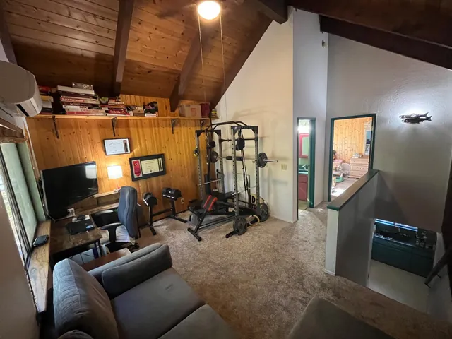 a bathroom with a granite countertop toilet sink and mirror