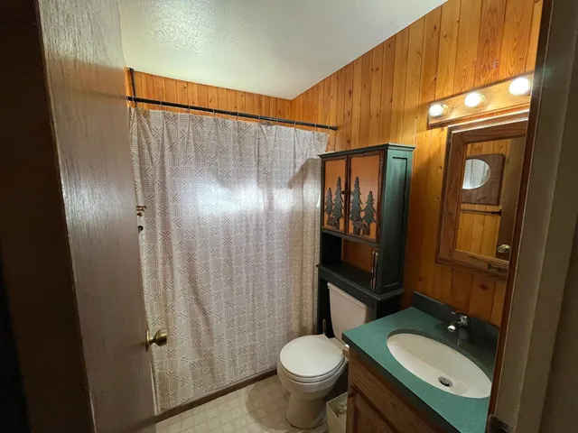 a bedroom with a bed and a chair