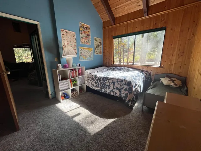 a bed sitting in a room next to a window