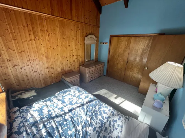 a bed sitting in a bedroom next to a window